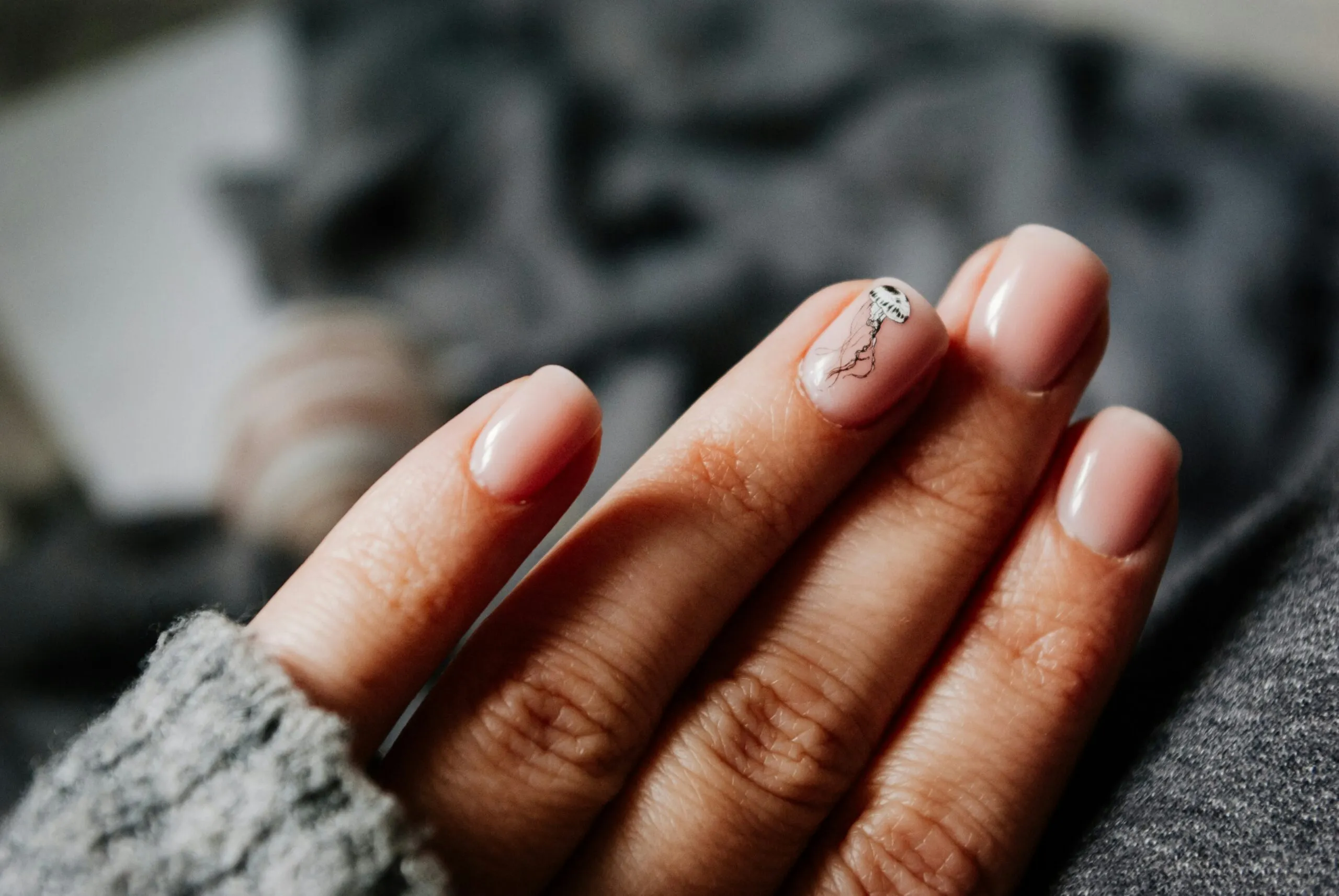 Soft pink nails with a whimsical jellyfish accent nail at Smayflower Nails in Gilbert, AZ – perfect for summer or ocean-inspired nail art lovers.
